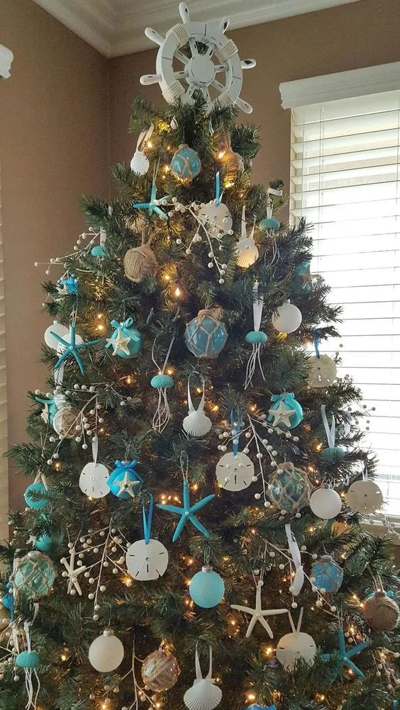 03-a-bold-beach-Christmas-tree-with-blue-and-white-ornaments-styled-as-floats-and-shells-plus...webp