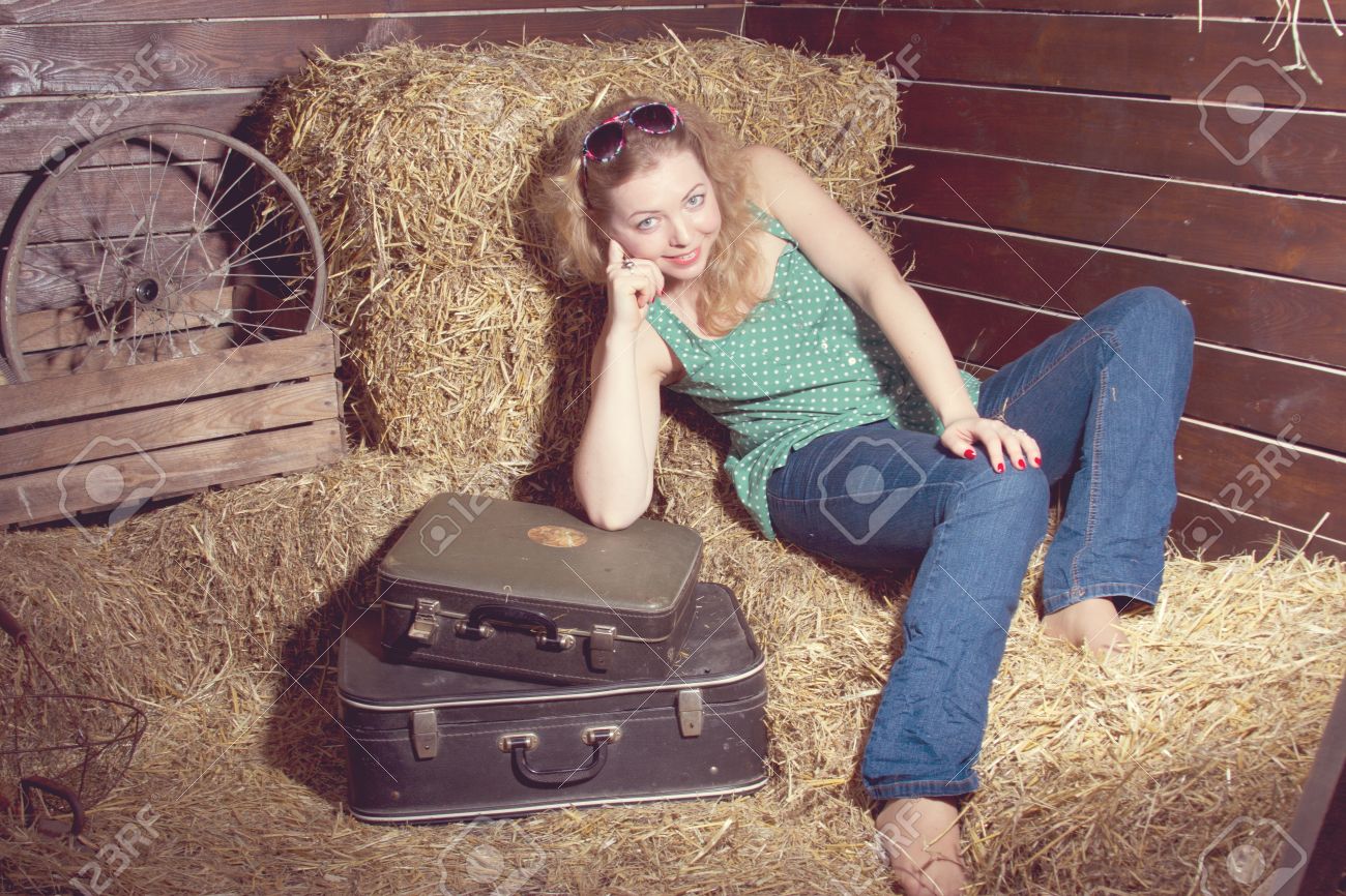 13278421-girl-in-the-hay-near-the-luggage-studio-shooting-Stock-Photo.jpg