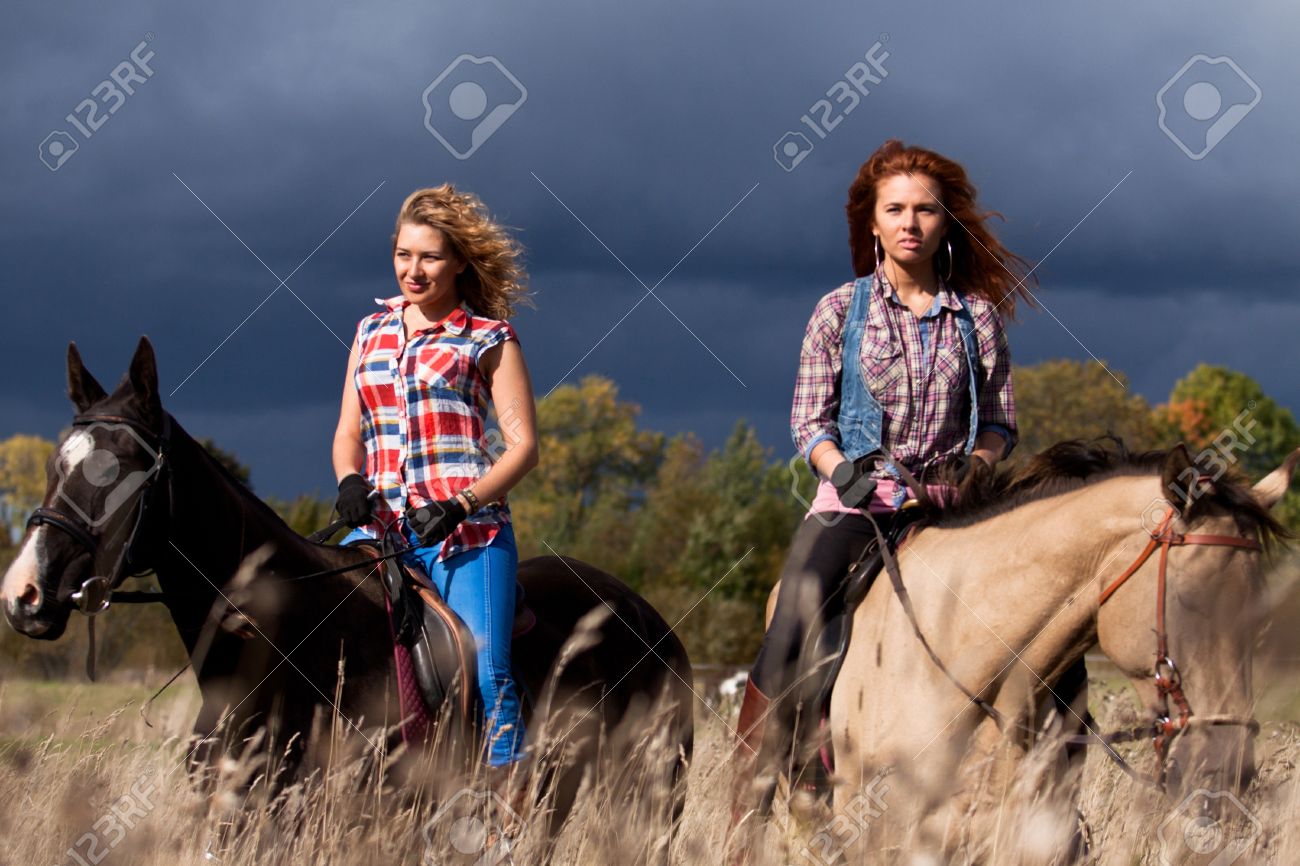 15431348-Two-girls-ride-beautiful-Akhal-Teke-horses-Stock-Photo-horse-riding.jpg