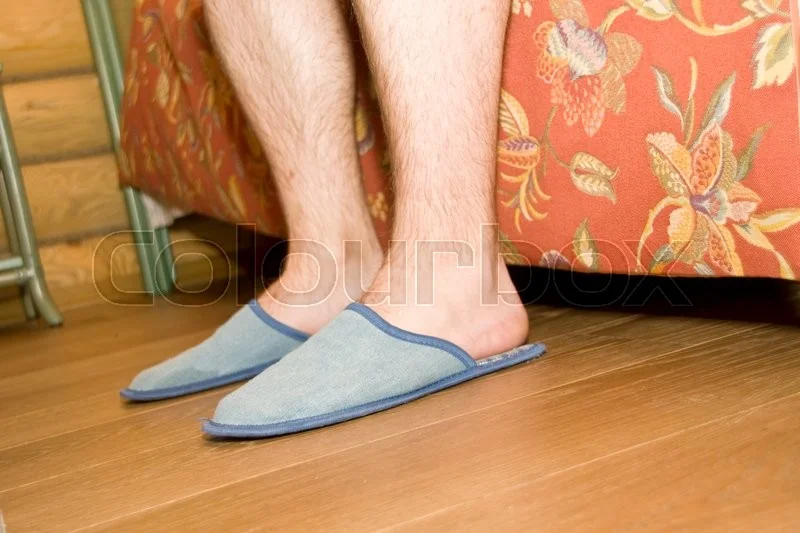 16374773-man-39-s-legs-in-slippers.webp