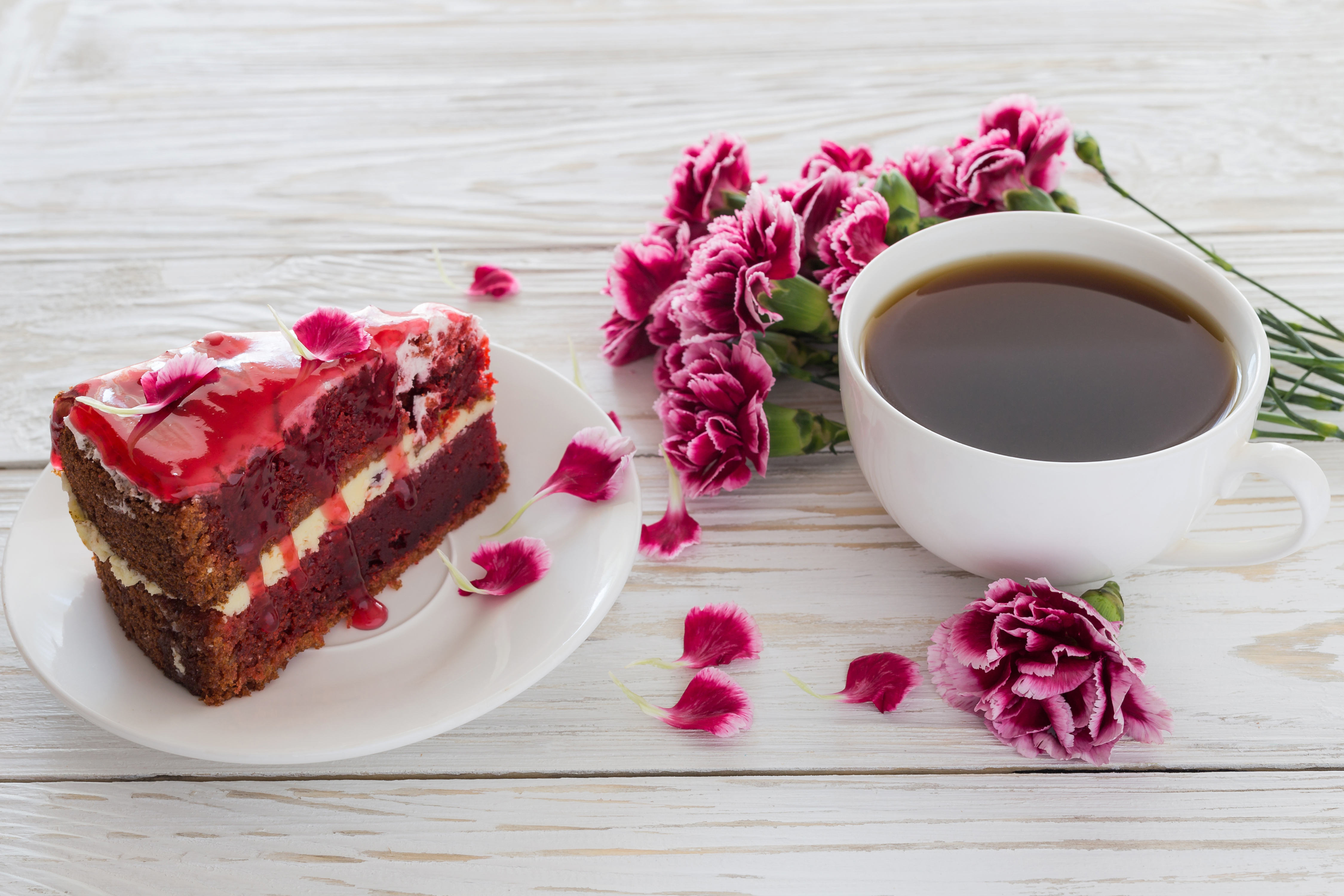 2019Food___Cakes_and_Sweet_A_piece_of_cake_on_the_table_with_a_bouquet_of_carnations_and_a_cup...jpg