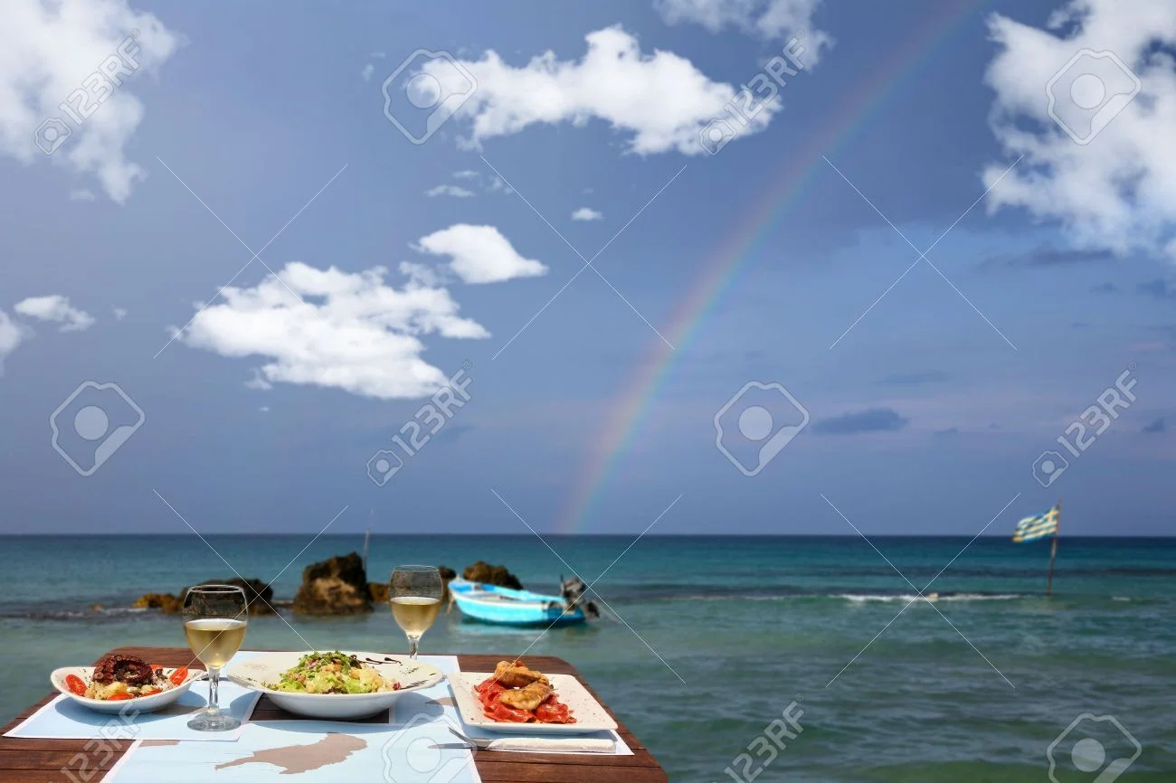 20559137-lunch-table-for-two-by-the-sea-with-nice-rainbow-Stock-Photo.webp