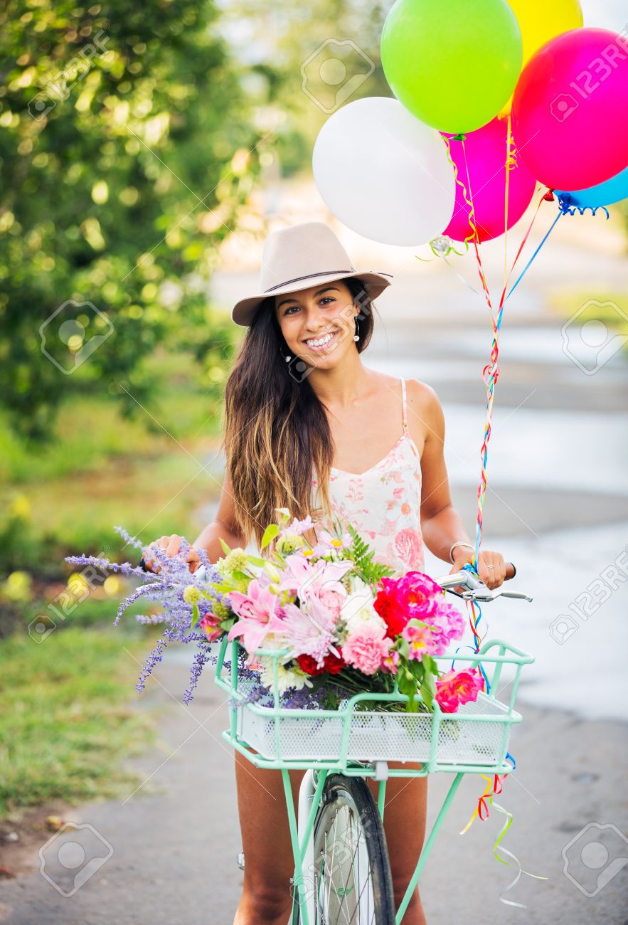 21578665-Beautiful-Girl-on-Bike-with-Balloons-in-Countryside-Summer-Lifestyle-Stock-Photo.jpg