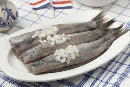 31741464-dutch-raw-herring-with-onions-on-a-dish.webp