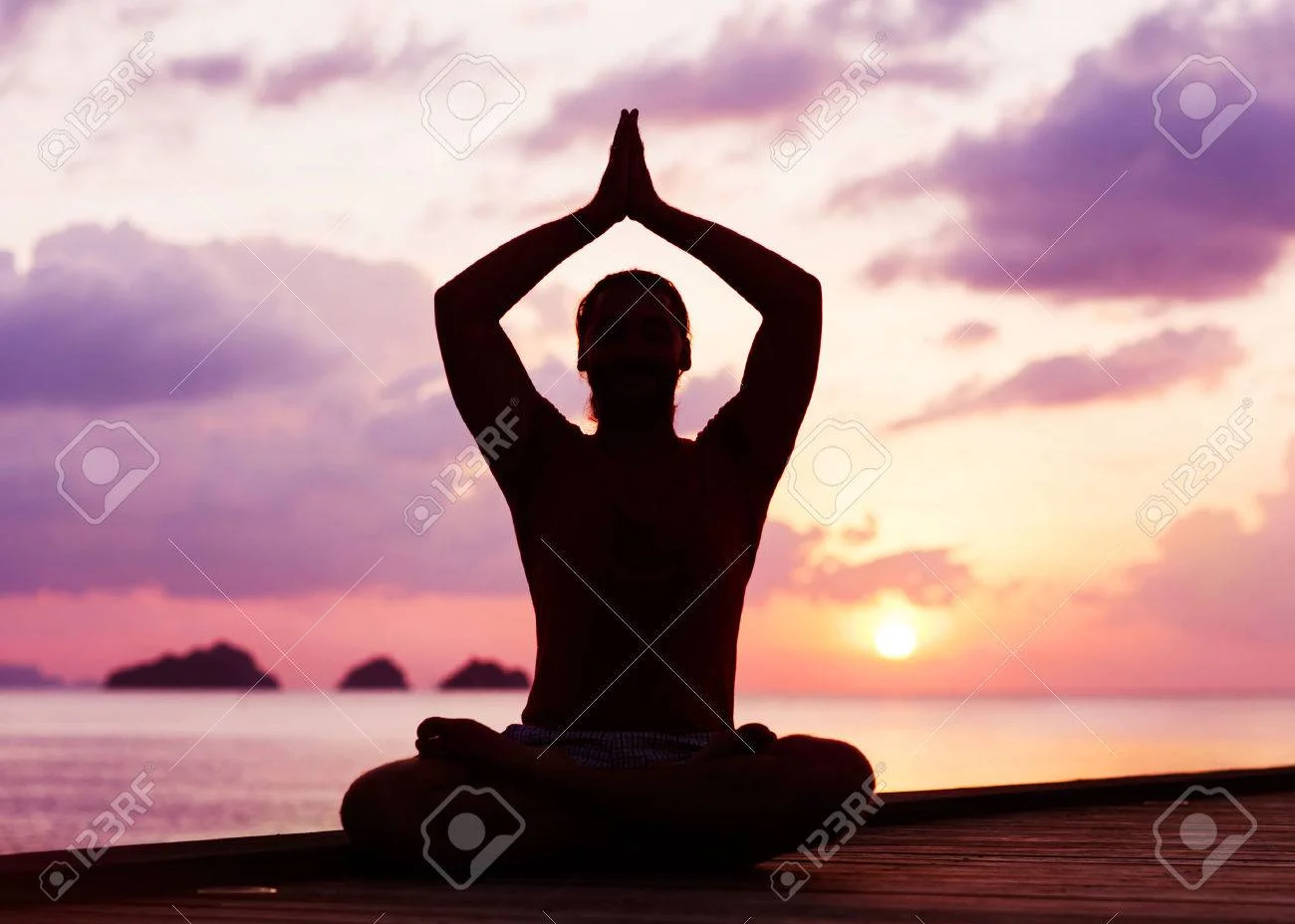 36428141-man-doing-yoga-at-sunset.webp