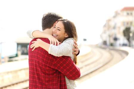 40441503-happy-couple-hugging-in-a-train-station-after-arrival.jpg