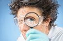 41509962-scientist-looks-through-a-magnifying-glass.jpg