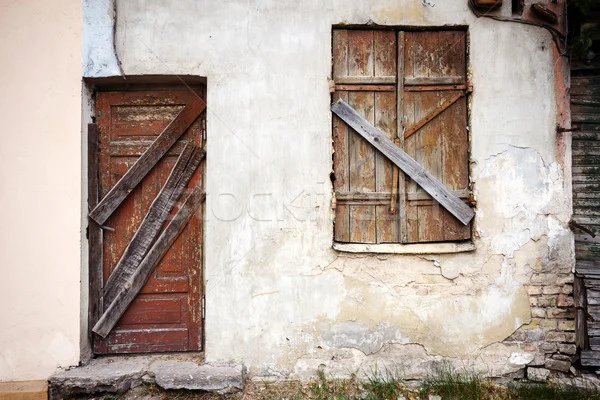 4303003_stock-photo-boarded-up-window-and-old-door.webp