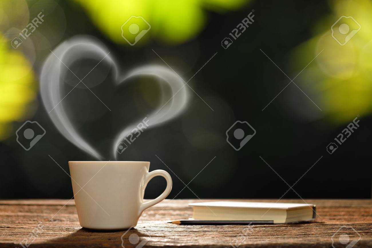 50024593-cup-of-coffee-with-heart-shaped-smoke-and-book-in-the-garden.jpg