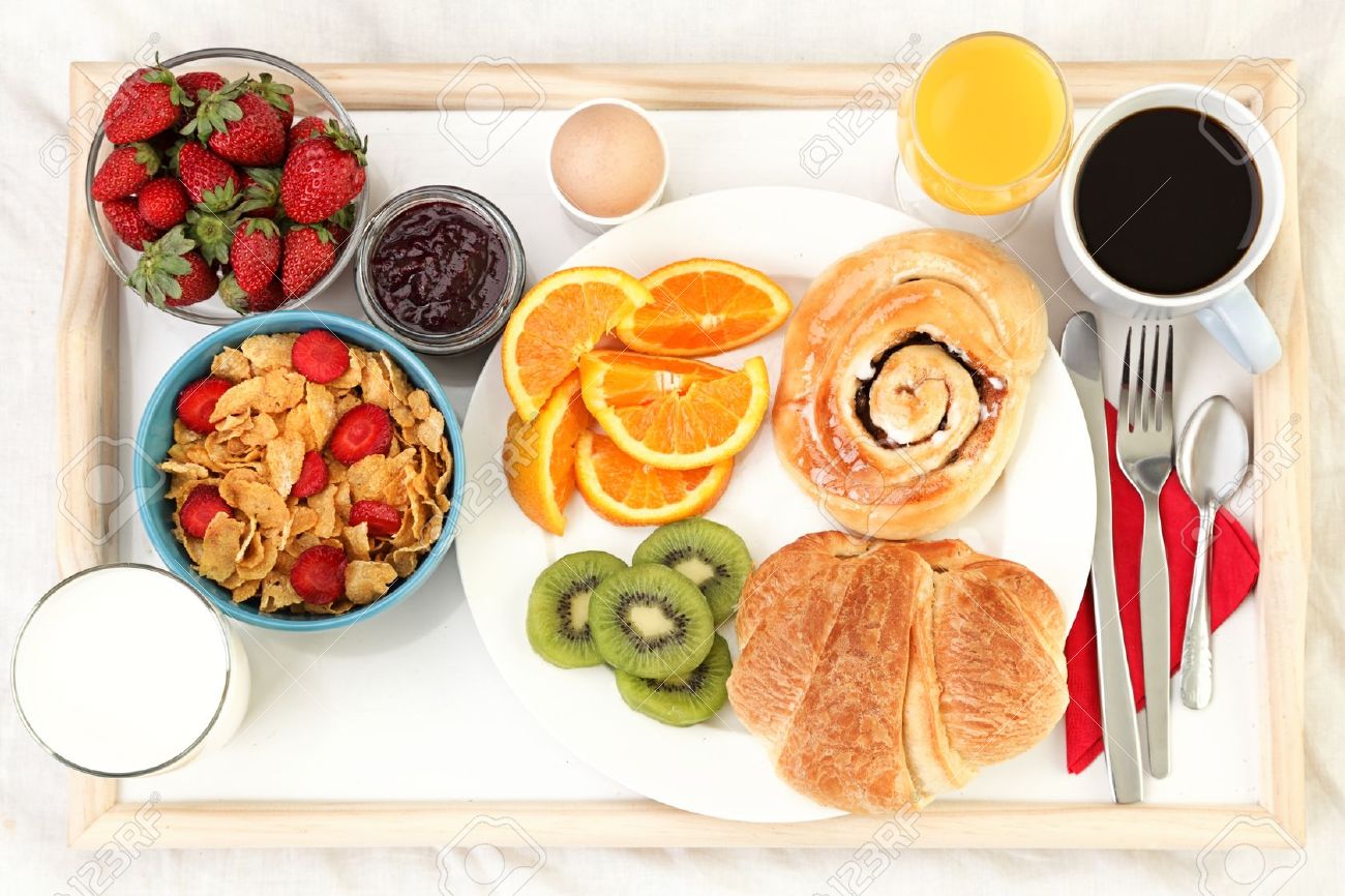 8513485-Breakfast-tray-in-bed-with-coffee-bread-cereals-fruit-etc--Stock-Photo.jpg