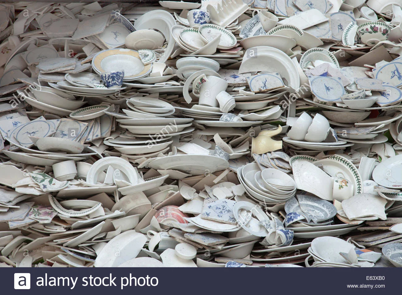 a-pile-of-broken-crockery-E63XB0.webp