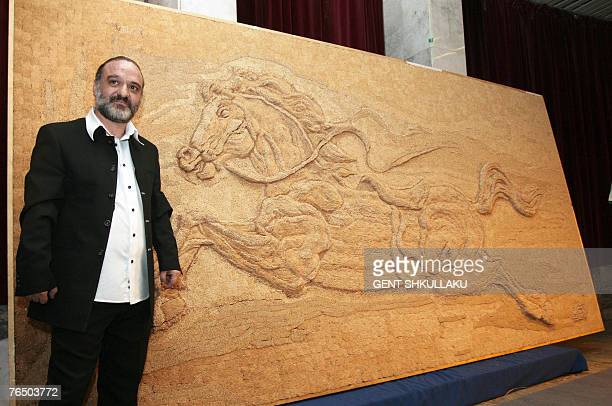 albanian-painter-saimir-strati-poses-in-front-of-a-horse-mosaic-made-with-toothpicks-at-the.jpg