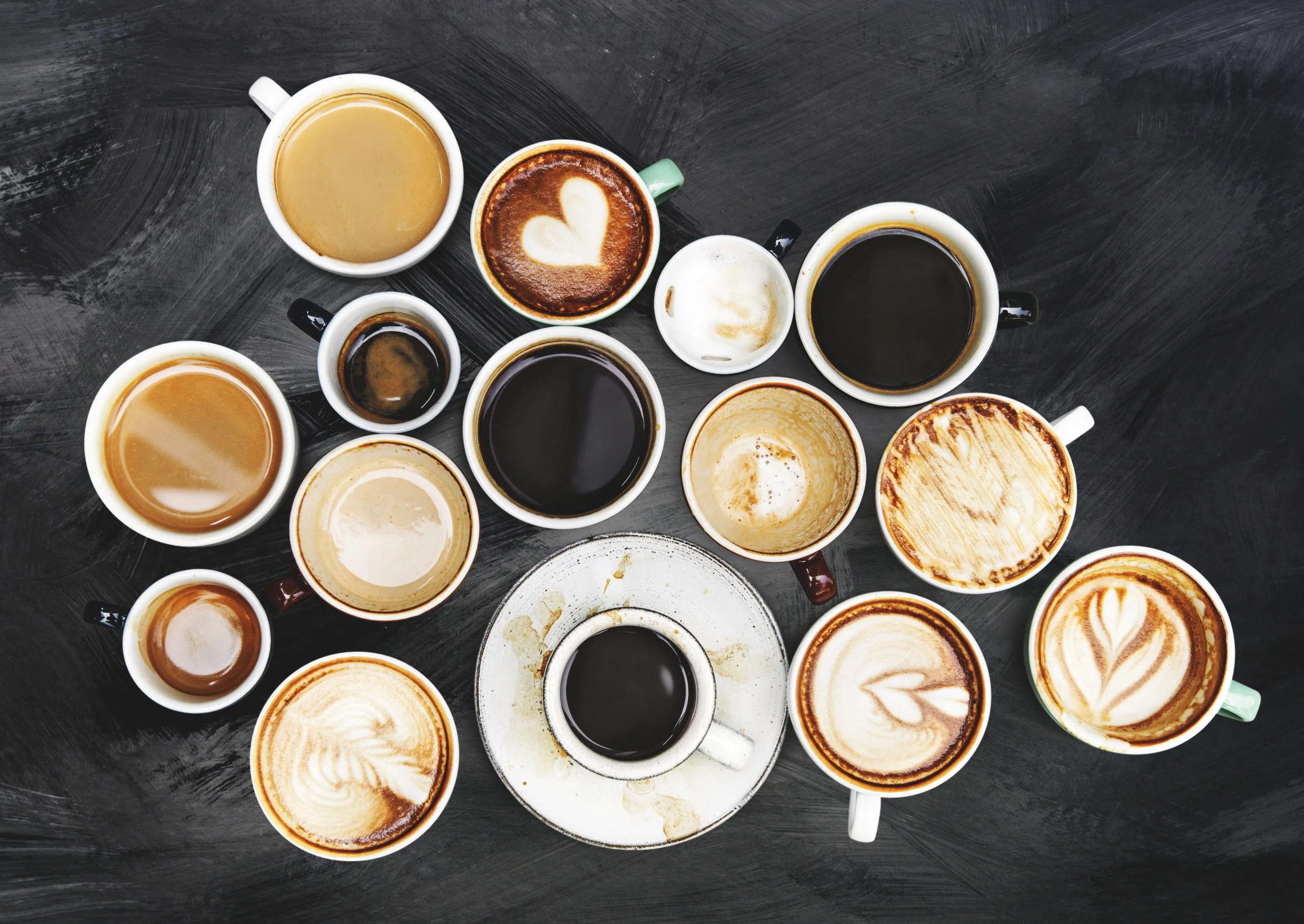 assorted-coffee-cups-textured-background-scaled.webp
