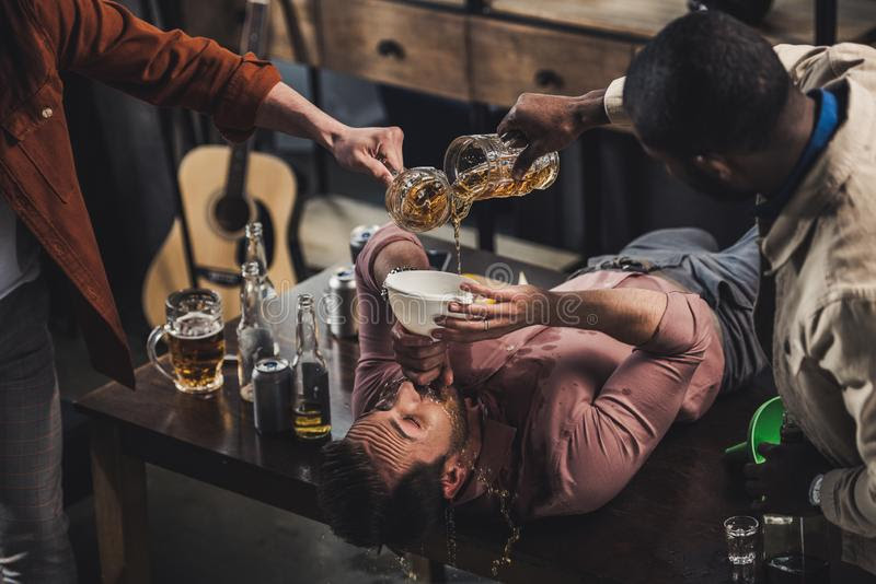 cropped-shot-friends-pouring-beer-funnel-man-cropped-shot-friends-pouring-beer-funnel-man-drin...jpg