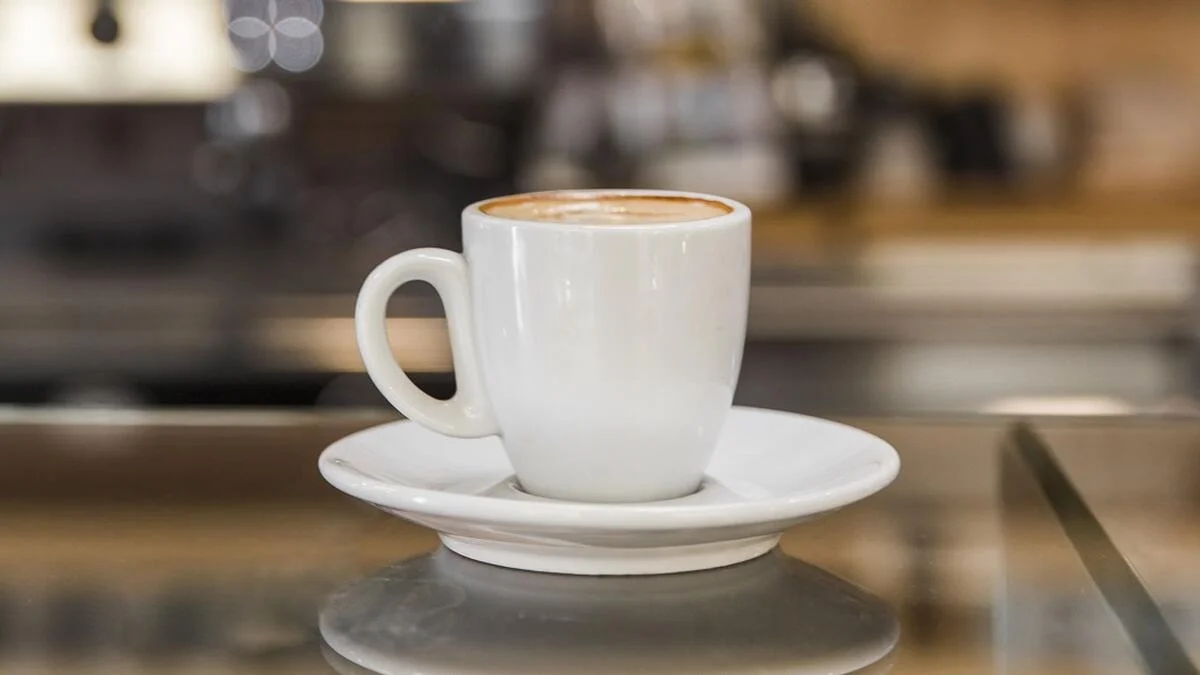 cup-of-cappuccino-on-glass-counter_1688953402_1688953540.webp