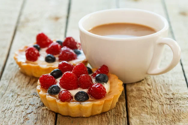 cup-of-coffee-and-sweet-cakes-with-berries_144962-3081.webp