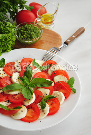 depositphotos_48774897-Caprese-salad-with-mozarella-cheese-tomatoes-and-basil.jpg