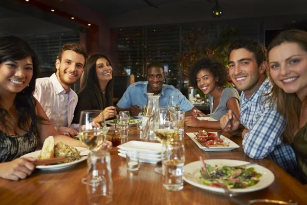 depositphotos_50473983-stock-photo-group-of-friends-enjoying-meal.webp