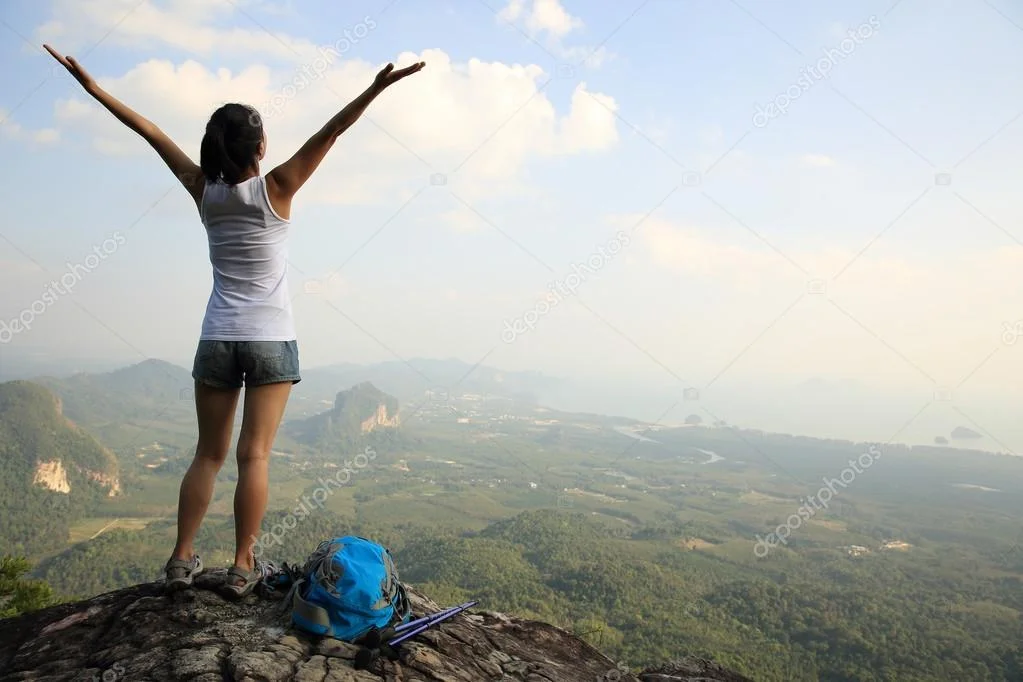 depositphotos_68457199-stock-photo-cheering-woman-at-mountain-top.webp