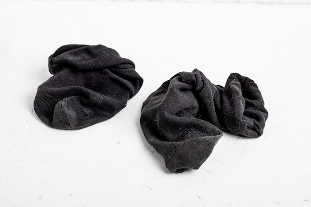 dirty-old-socks-white-background-wrinkled-worn-men-s-black-socks_209484-10691.jpg