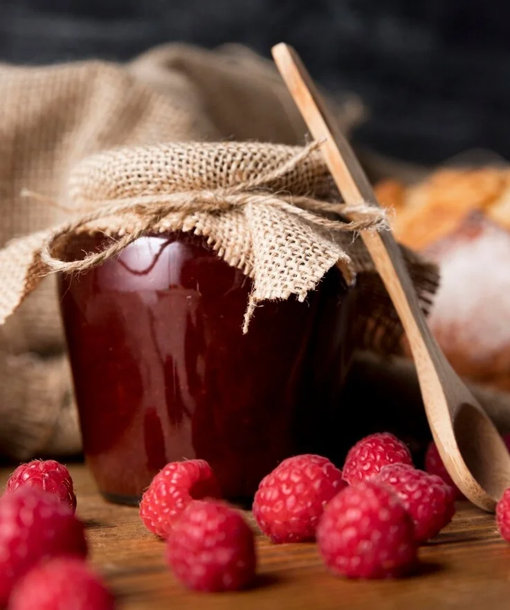 front-view-raspberries-with-jam-jar_23-2148585334.webp