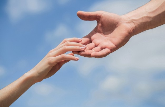 hands-of-man-and-woman-reaching-to-each-other-support-solidarity-compassion-and-charity-rescue...jpg