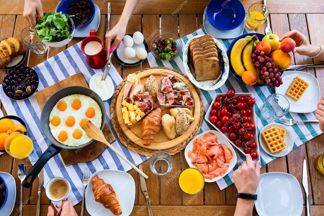 laid-table-with-foodbreakfasts-on-the-table-top-viewlarge-table-with-food-top-view-summer_167...webp