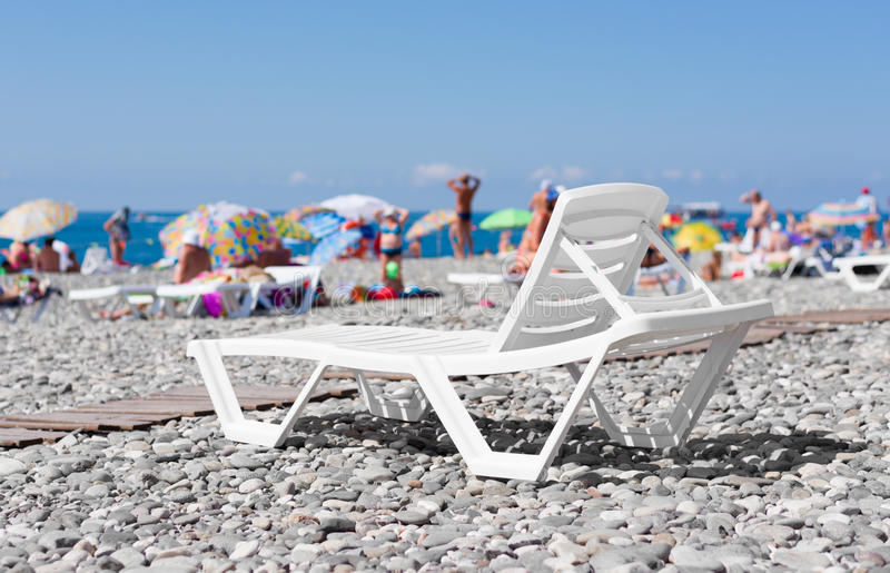 lounger-white-plastic-beach-sea-background-people-sunbathing-58656242.jpg