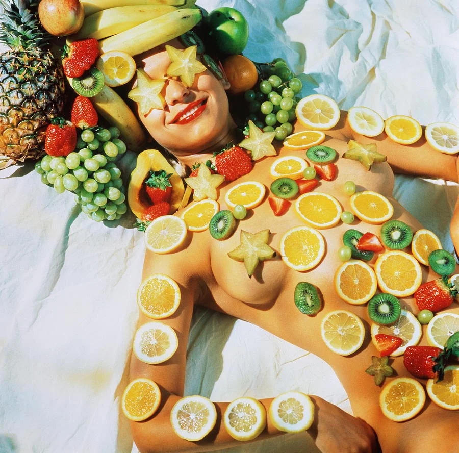 reclining-naked-woman-covered-with-fruit-donna-day.webp