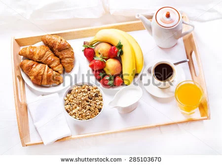 stock-photo-breakfast-in-bed-tray-with-coffee-croissants-cereals-and-fruits-285103670.webp