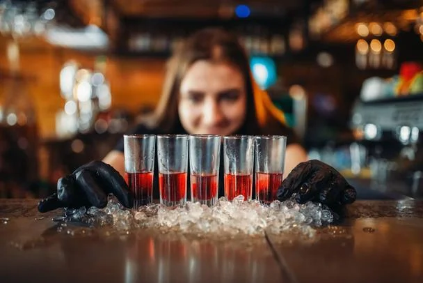 stock-photo-female-barman-gloves-puts-drinks.webp