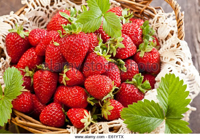 strawberries-in-basket-on-rustic-wooden-background-e61ytx.webp