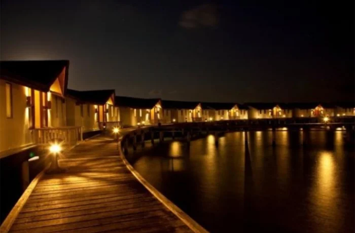 Водные_виллы_вечером,_Reethi_Beach_Resort.webp