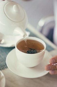 focused_155243402-stock-photo-pouring-tea-into-cup.jpg